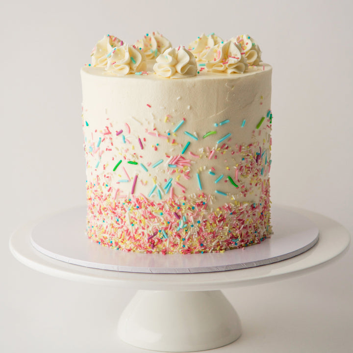 Vanilla sponge cake with sprinkles. Swiss meringue buttercream and jam. London delivery