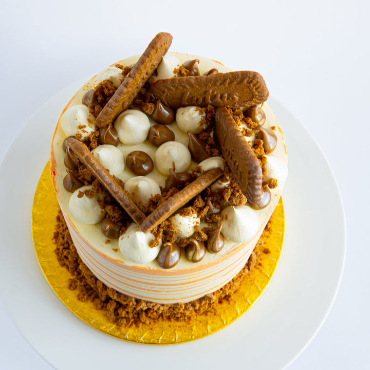 Biscoff Carrot cake decorated with Lotus biscuits and tangy cream cheese frosting.