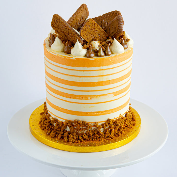 Biscoff Carrot Cake by Punk Cake. With a sweet, spicy Biscoff spread, tangy cream cheese frosting, biscuit decorations and a moist carrot cake sponge. 