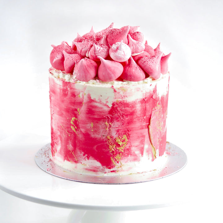 lemon, raspberries and cream layer cake with pink meringue  decoration. 