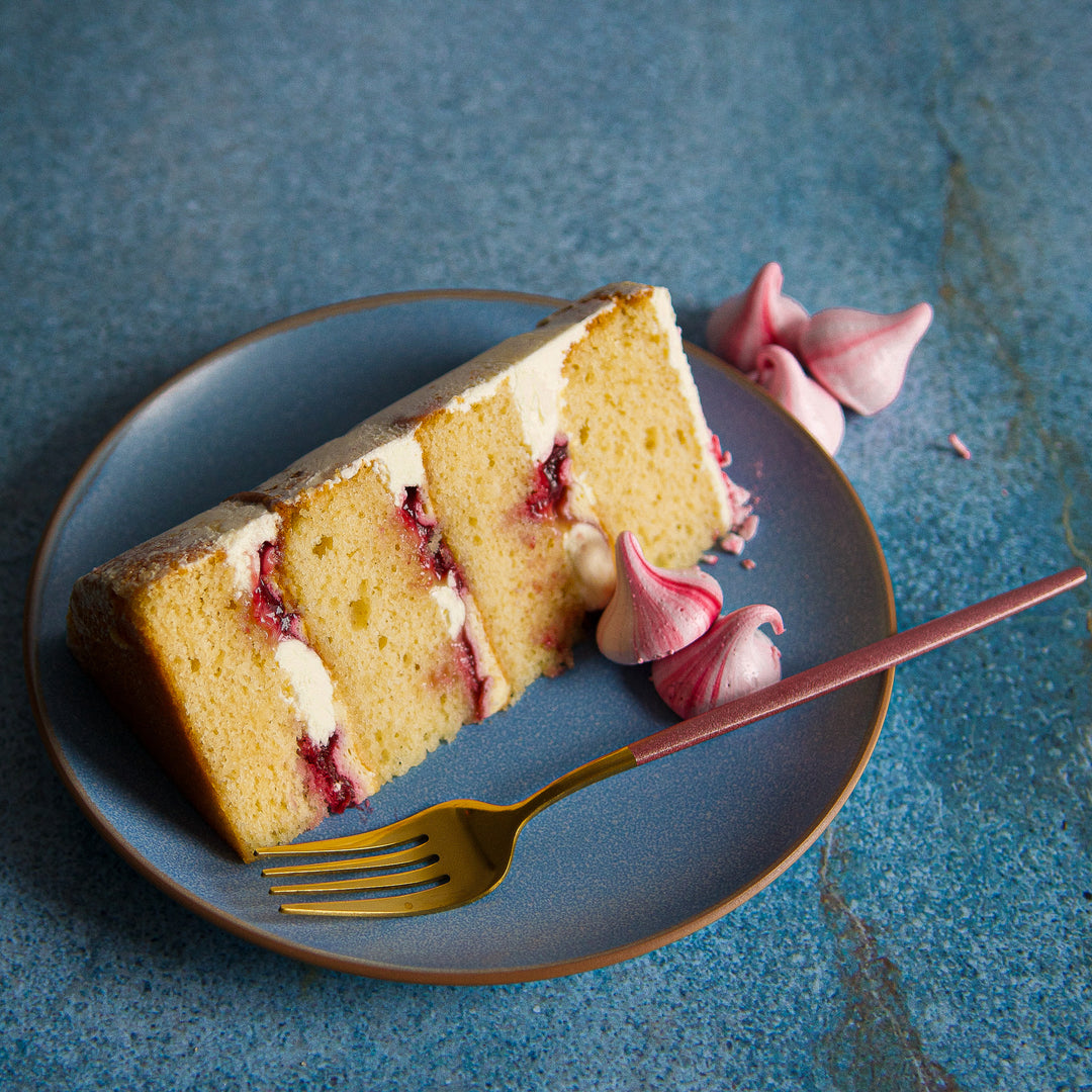 Lemon raspberries and cream layer cake with homemade raspberry compote. Individual cake slice