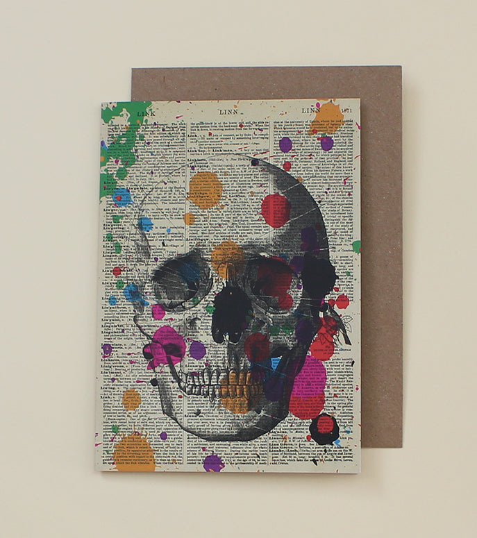 Colourful card, with scull, paint splats and old book page background. Punk Cake greeting card for birthdays and celebrations.